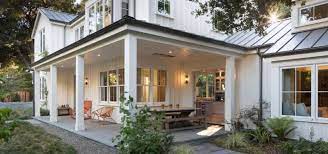 A nicely detailed covered porch wraps around three sides of this farmhouse design extending the living area to the outdoors. 17 Modern Farmhouse Wrap Around Porch Ideas Sebring Design Build