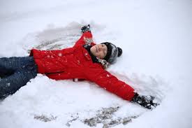 Premium Photo Teenager Lies In The Snow And Making Snow Angel