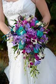 My bridesmaids wore very bright colors, so i wanted the flowers to be more muted/subtle. Gorgeous Peacock Wedding Bouquet I D Like A Solid White Bouquet For Myself But This Is A G Peacock Wedding Bouquet Peacock Wedding Theme Wedding Bouquets