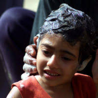 In a small village in northern Iraq, an Iraqi doctor with assistance from  members of US Army (USA) Task Force 1ST Battalion, 63rd Armor Regiment  (1-63 Armor), Vilseck, Germany, inoculates villagers against