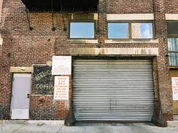 Build a brick garage doityourself. Dirty Garage Door In An Old Brick Building In The City By Holly Clark