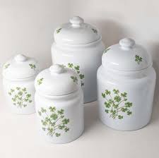 Large 8d x 16t | medium 8d x 14.5t set of 4 ceramic canisters with red apples painted on them. White Canister Set 4 Piece With Shamrocks