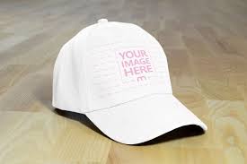 A Realistic Cap Hat Mockup Generator With A Blank Hat Lying On A Wooden Background Surface Caps Hats Mockup Hats