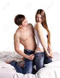 Young Man Undressing Beautiful Girlfriend In Bed On White Background Stock  Photo, Picture and Royalty Free Image. Image 18435722.
