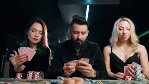 A Sad Bearded Man and Two Girls Are Loses To a Card Game at a Casino by  olegbadak