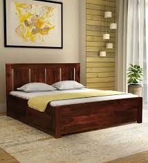 Latest wooden bed design crafted in modern style is a neutral and earthy furniture design that will be a perfect fit for a modern bedroom. Denzel Solid Wood King Size Bed With Storage In Honey Oak Finish Shagun Arts
