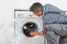 Technician repairing washing machine