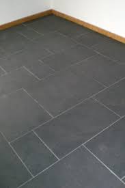 Slate herringbone pattern floor tiles in a transitional bathroom includes a seamless glass shower with large white and gray marble staggered wall tiles. Slate Floor Tiles For Kitchens And Bathrooms In Black Grey Cinza