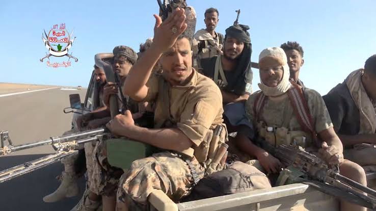 Yemeni government fighters shown driving vehicles over Houthi opponents | Reuters