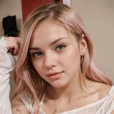 A close up of a woman with pink hair and a white top