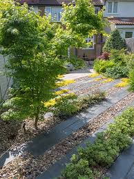The Design For A North London Garden Is Inspired By Modern Japanese Influences Bold Lines Set At A 45 Front Garden Design Modern Garden Modern Garden Design