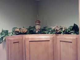 Above Kitchen Cabinets Decorations Diy Fill Empty Wine Bottles With Rocks Sand Noodles Shells Etc Above Kitchen Cabinets Kitchen Cabinets Decor Diy Decor