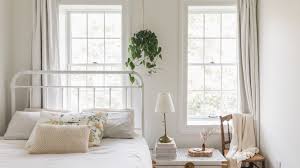 The best way to give a room's inconsistent windows a cohesive appearance is by using a single style of window treatment on them. Feng Shui Tips For A Bed Under A Window