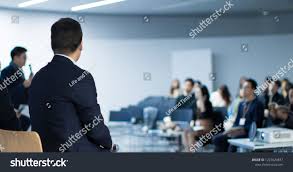 Panel Speaker On Stage Presenting Vision And Ideas Conference Lecture Hall Blurred De Focused Unidentifiable Prese Lectures Hall Business Technology Attendee