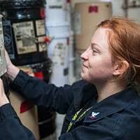 Machinist Mate 3rd class Tyler Stoup verifies Hazardous Material (HAZMAT)  has been correctly stored aboard the aircraft carrier USS George Washington  (CVN 73).