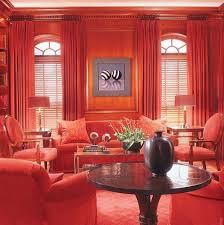 Though the space is cozy, the uniform color scheme helps it feel tidy and cohesive. Ad 100 Thomas Pheasant Red Rooms Living Room Red Interior Design