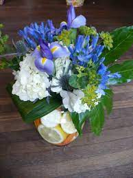 Hydrangea Agapanthus Iris Bupleurum With Lemons And Mini Carrots Flower Arrangement Flower Arrangements Mini Carrots Flowers