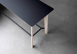 The table features a unique metal sled base and aluminum top which can fit in a variety of home decor needs. Eoos