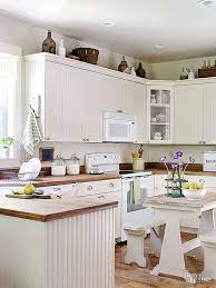 Beaded Board Cabinets And Weathered Wood Countertops Set The Stage For This Vin Above Kitchen Cabinets Kitchen Cabinets Decor Decorating Above Kitchen Cabinets