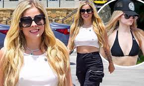 Avril Lavigne sparks boob job rumors as she shows off VERY busty look while  going braless in top | Daily Mail Online