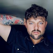 A cheeky Wigan fund-raiser took a chilling plunge after hitting a charity  target