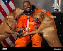 Leland Melvin with his dogs, Jake and Scout. "I snuck them into NASA to get  this picture," Melvin says  NASA-astronaut-Leland-D-Melvin-with-his-dogs-Jake-and-Scout-thumb-560x448  Stock Photo