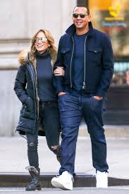 Jennifer Lopez And Alex Rodriguez Lead The Paparazzi Around A European Vanity Fair Plus tartan print wide leg pants.