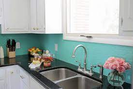 By using monochromatic subway tile in a pretty blue with an intricate mosaic inlay, this kitchen backsplash idea went from drab to fab in a cinch. Diy Kitchen Backsplash Ideas