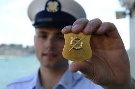 Petty Officer 2nd Class August Lowry holds up his