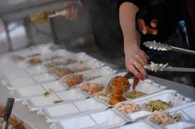 Assembly line of volunteers feed turkey dinners to thousands of needy  people across Denver â€“ The Denver Post