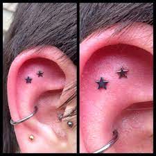 Double Outer Conch With Anodized Dark Blue And Rose Gold Stars From Neometal Earings Piercings Ear Piercing Studs Piercings