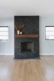 Black And White Fireplace Wall Dark Stone Fireplace Flanked By Black Windows This Dark Stone Fireplace Features Sl Stone Fireplace Makeover Brick Fireplace Makeover Stacked Stone Fireplaces