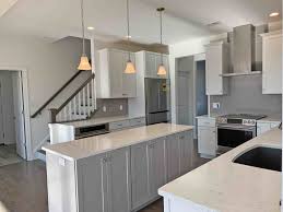 The clean lines of this modern kitchen cabinet design are completed with a smooth pebble grey paint. Soft Contemporary Kitchen In Nazareth Pa Morris Black Designs