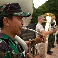 Senior Chief Musician Joseph Rundall, left, Musician 3rd Class Amanda Ginn  and Musician 3rd Class David Drescher play the saxophone at a Big Top  reception aboard USS Blue Ridge (LCC 19). -