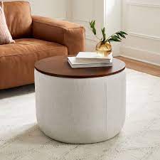 The contemporary square ottoman can be used as a coffee table in the living room. Upholstered Round Storage Ottoman