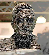 It shows turing seated and looking at a german enigma machine. Alan Turing New World Encyclopedia