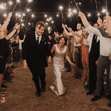 The groom steals a kiss from his adorable bride while holding one of our 36 inch sparklers. 39 Unforgettable And Unique Wedding Send Off Ideas