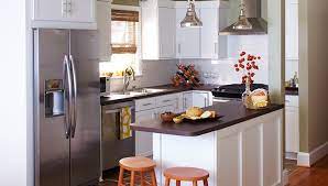 A modern kitchen merged with a small living room in black and white. Top 10 Open Plan Kitchen Living Room Ideas For Small Spaces