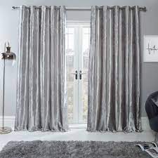 Draw this single blackout curtain panel across your window before you go to bed to prevent morning sunlight from disturbing your sleep. Sienna Home Crushed Velvet Eyelet Curtains Silver