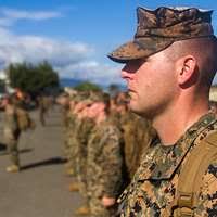 Capt. Anthony D. Suh speaks to the Marines and Sailors