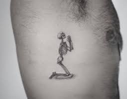 Rose hand tattoos are suitable for ladies as this flower is often a sign of femininity and beauty. Prayer Micro Realist Skelleton Tattoo