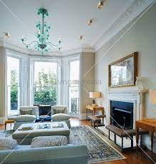 Traditional Living Room With Bay Window Green Glass Chandelier Above Sofas And Fireplace In 2021 Bay Window Living Room Living Room Bay Window Edwardian Living Room