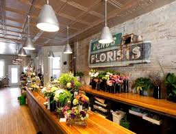 I Know It Sounds Crazy But I Want A Reclaimed Brick Wall Like This And Old Wood Highly Lacquered Counters F Flower Shop Design Flower Shop Flower Shop Display