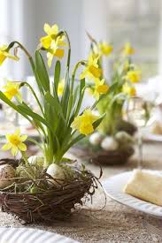 simple easter flowers a nest filled with daffodils and miniature eggs easter tablescape idea fleurs de paques deco paques decoration paques