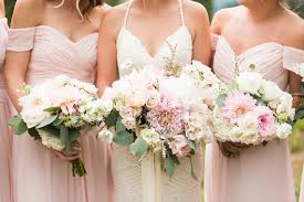 N hand with luxury rings on background of pink rich dress. Wedding Dress Lace And Lilies Blog