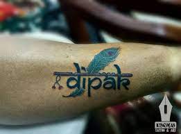 Name Tattoo Dipak With Flute Feather Tattoos Art Tattoo Popular Tattoos