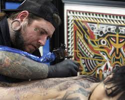 True colors: Tattoos peeking into mainstream workplace