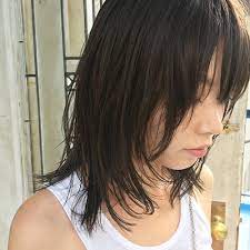 ストレートにセットした前髪ありのウルフ風ミディアムレイヤーヘアスタイル ロブヘアスタイル ミディアム パーマ 前髪あり ミディアムロングヘアカット