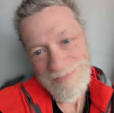 Should I use paint stripper or sand before repainting a solid wood vanity?