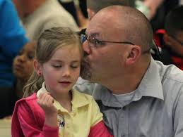 Thousands of dads and fatherly figures walk children to school; groups  collaborate